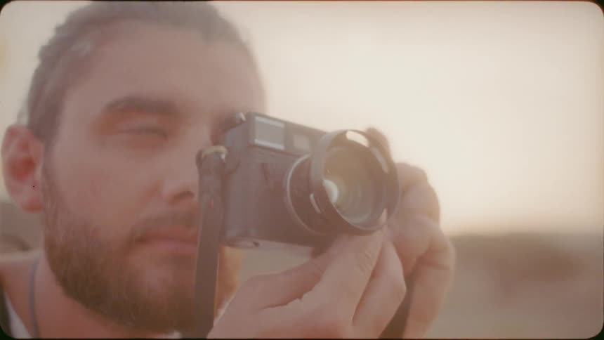 Man takes a picture outside on a sunny day