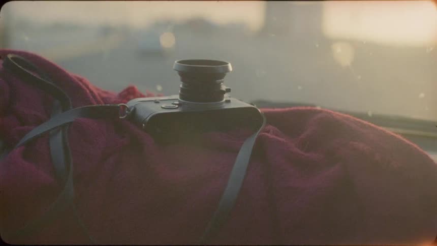 A camera sits on the dashboard of a moving car