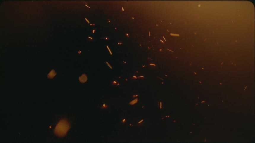 Embers are blown from a fire by the wind