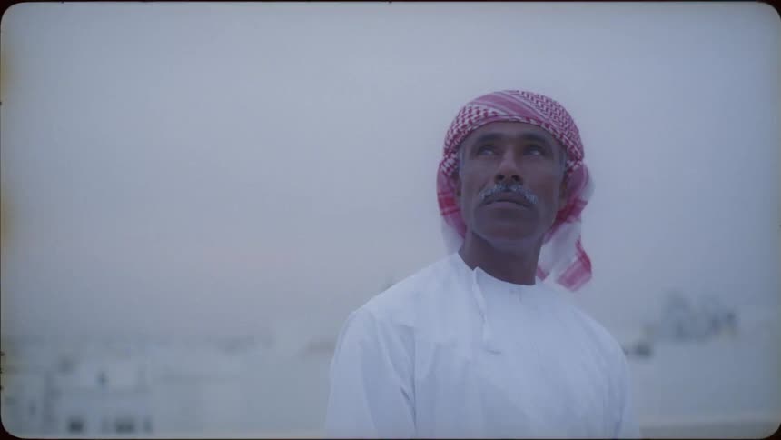 A man looks out at the view from the roof