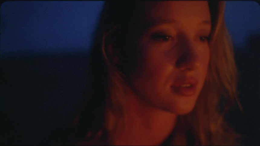 A woman turns to her side while talking at night