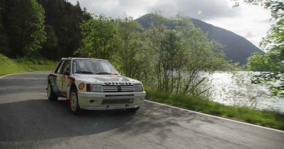 A car turns around the road by the lake
