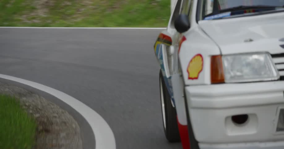 A touring car speeds on the road