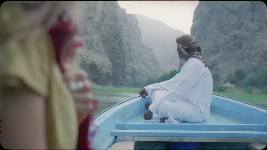 A man and woman ride in a boat