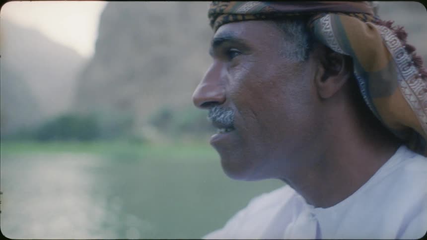 An arab man looks out at the river water