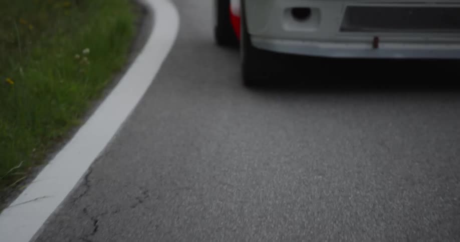 A touring car speeds on the road