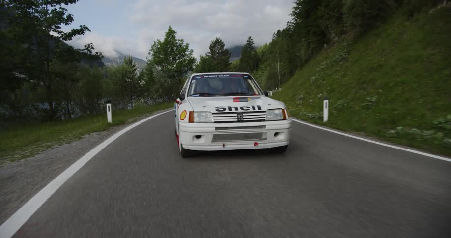 Race car driving along a country highway