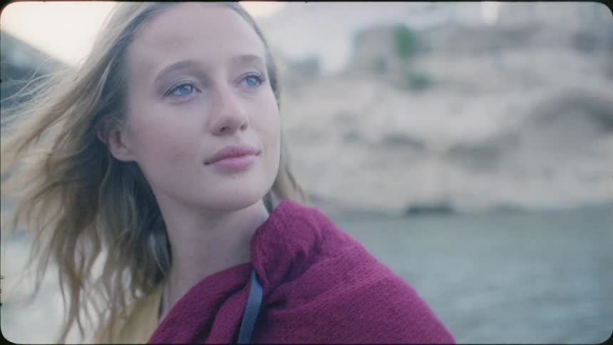 Woman on a boat faces the wind