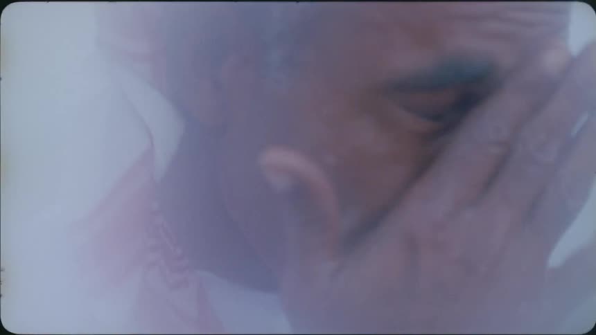 Man wipes his face on a foggy day