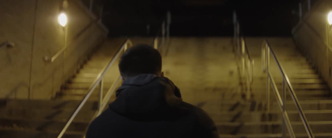A man walks towards the stairs