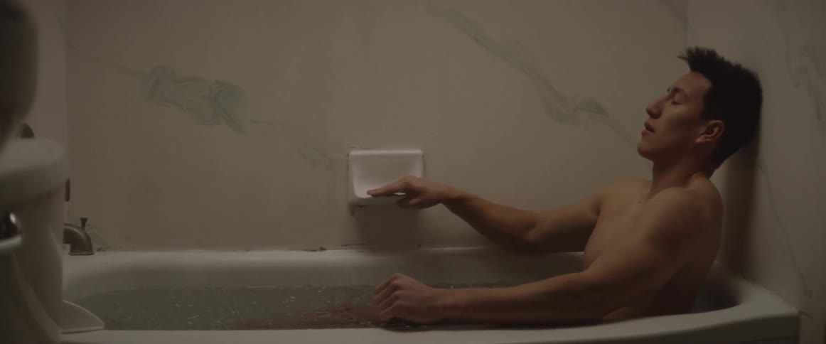 Person grabs a soap holder in a bathtub