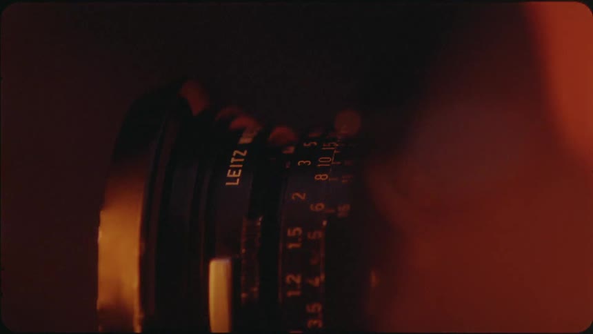 A camera lens is being adjusted at night