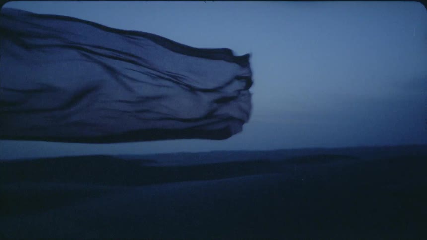 Scarf is blowing in the wind in wilderness after sunset