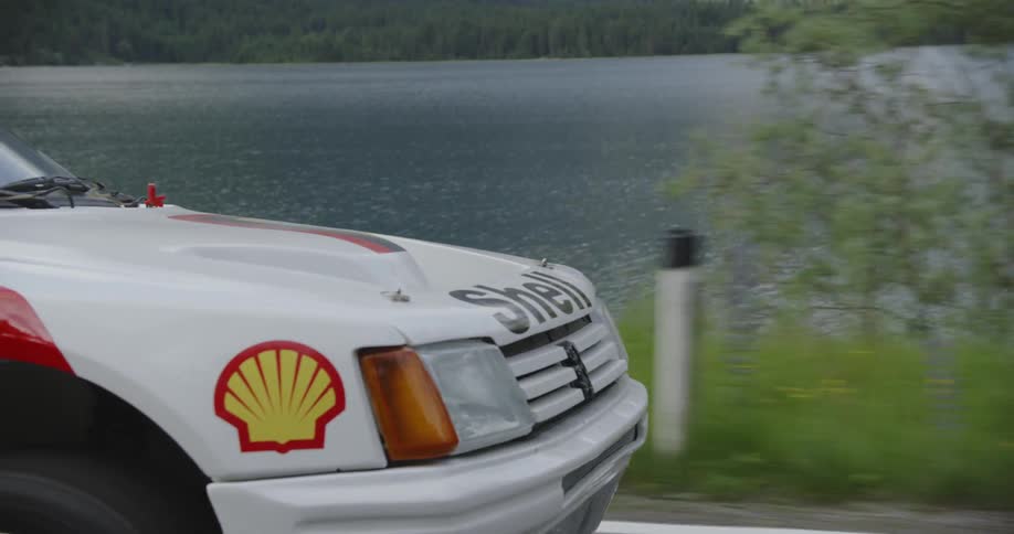 A touring car speeds on the road
