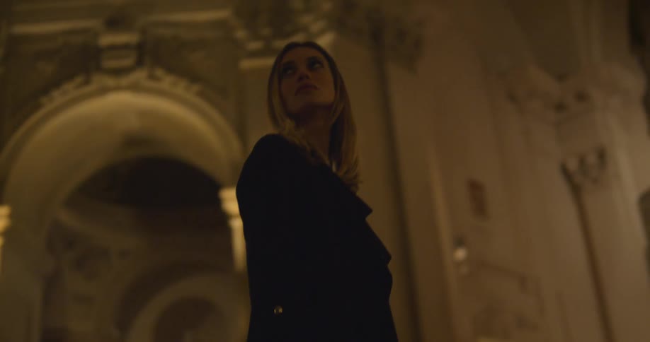 A woman standing in a dark church