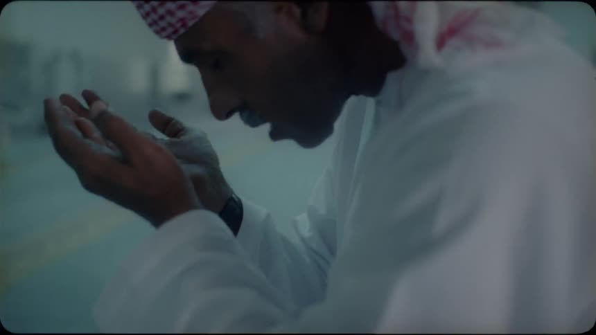 Man wearing head wrap is praying in church