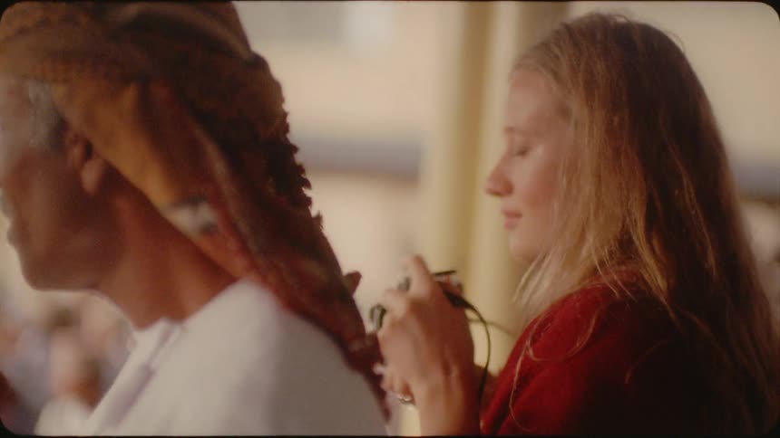 A blond haired woman takes photographs