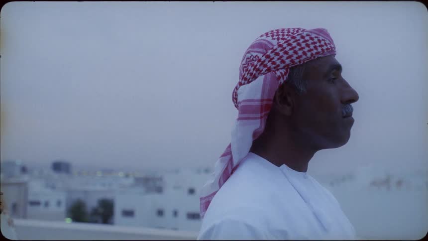 A man stands on the rooftop on a cloudy day