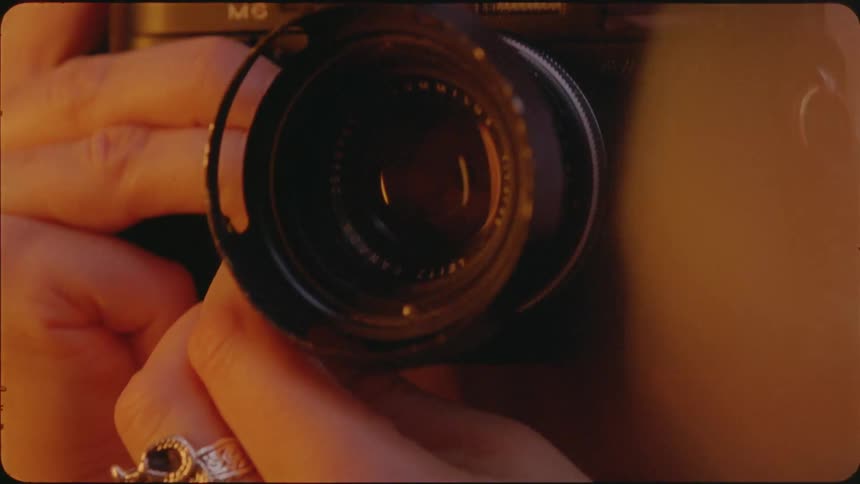 Woman wearing a ring holds a camera