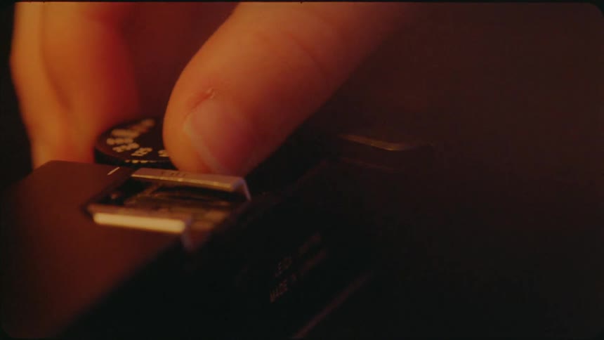 A person presses the switch on a camera