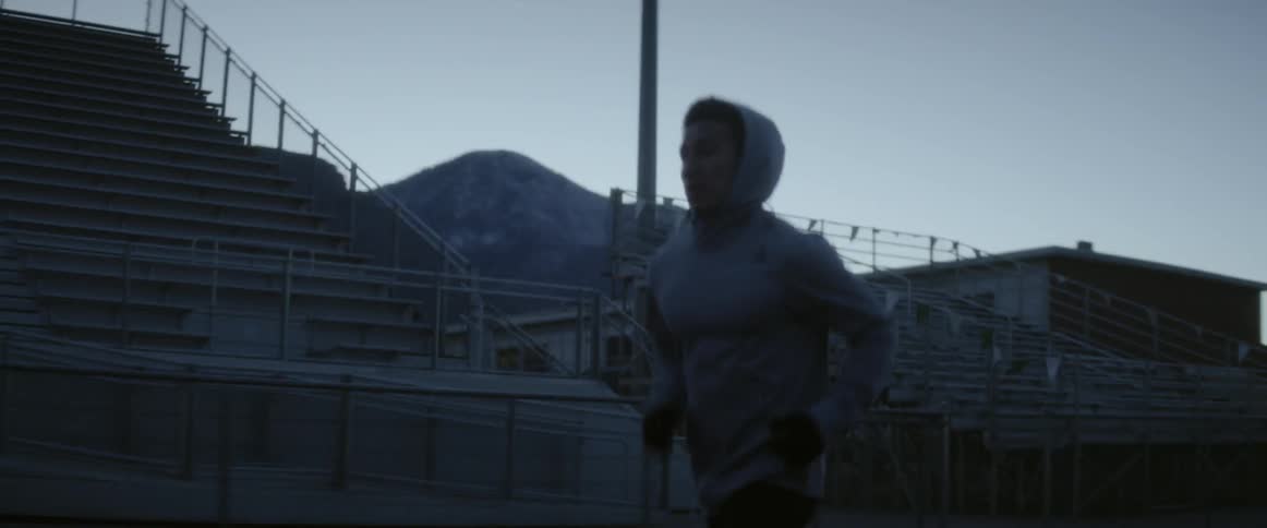 Man runs on a track in the dark