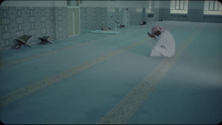 Man kneels and prays in a temple