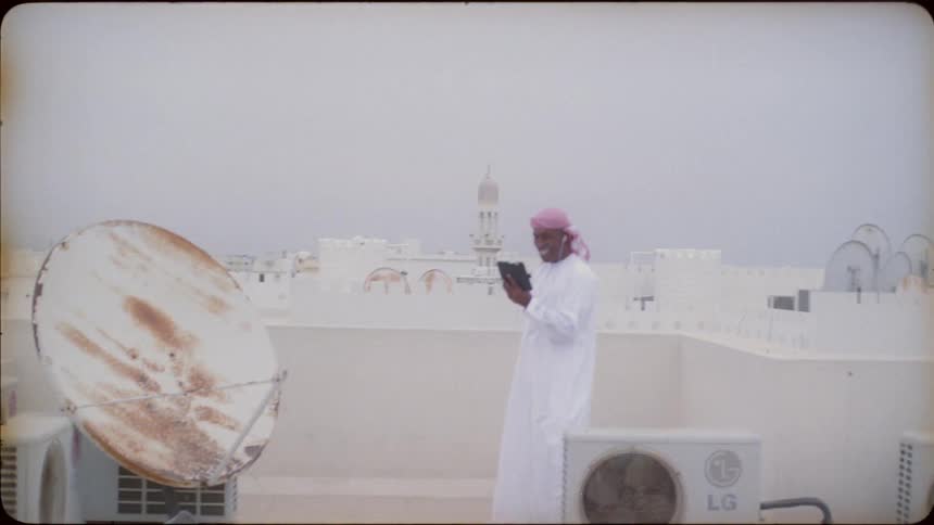 Man stands on roof video calling on phone