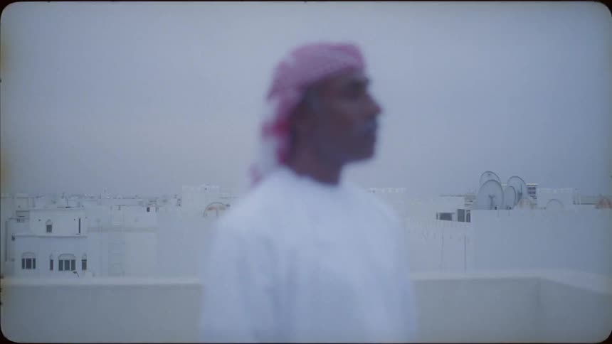 The man stands on the roof looking around