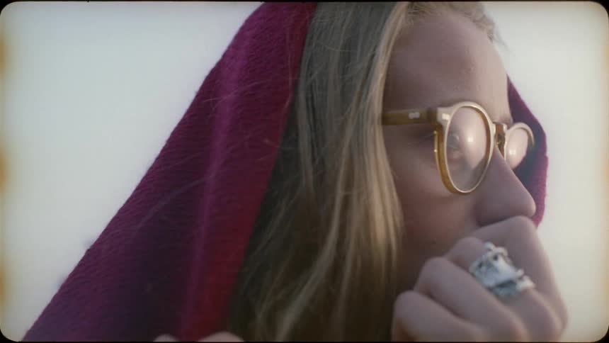 Woman shields her face with a cloth
