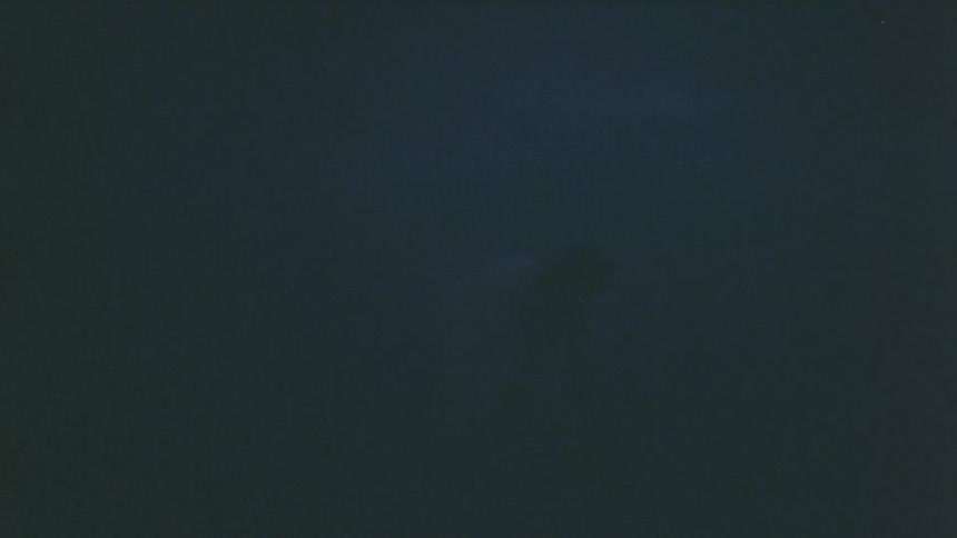 Lightning briefly illuminates a person walking in the dark