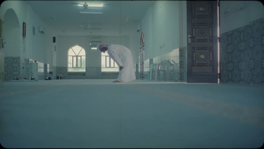 Man stands in a temple and bows
