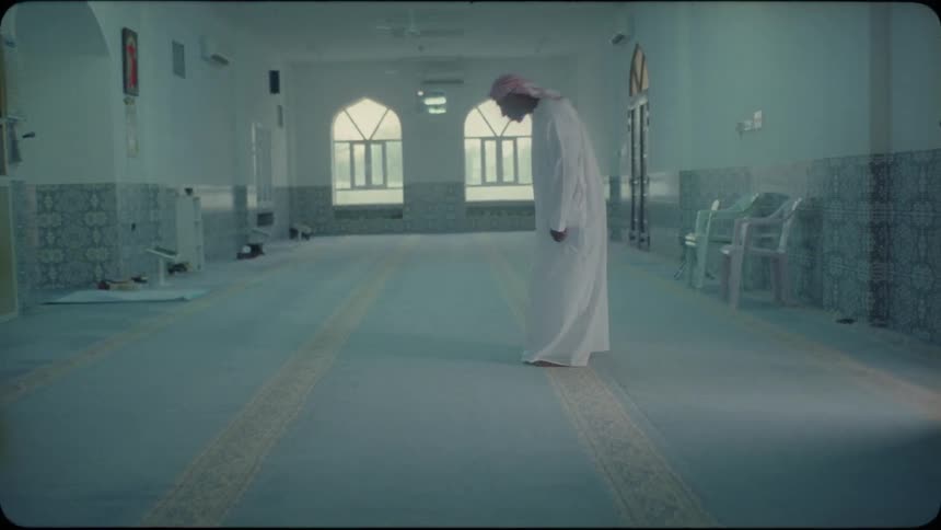 An arab man kneels down and prays