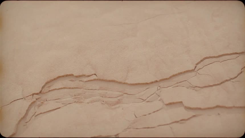The desert floor begins to break apart