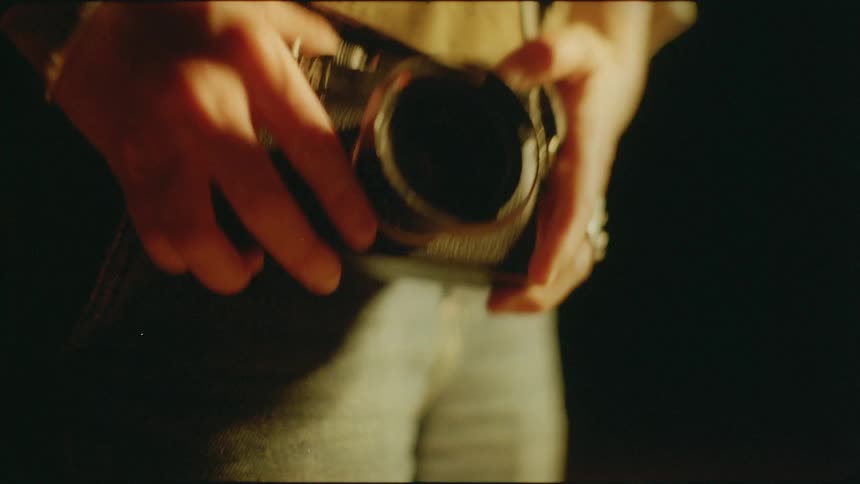 A woman holds her camera outside