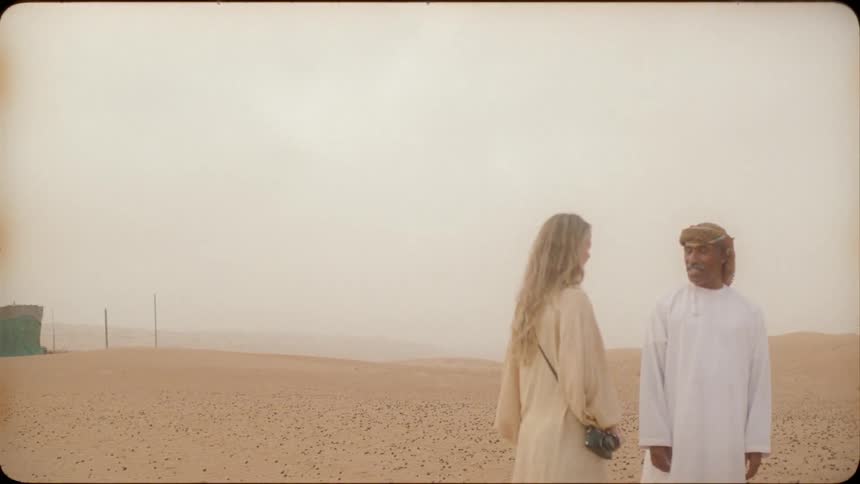 Man and woman stand in the desert and talk