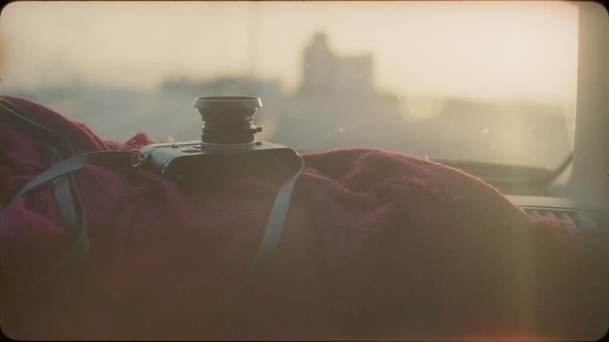 Camera in the backseat of a car on a sunny day