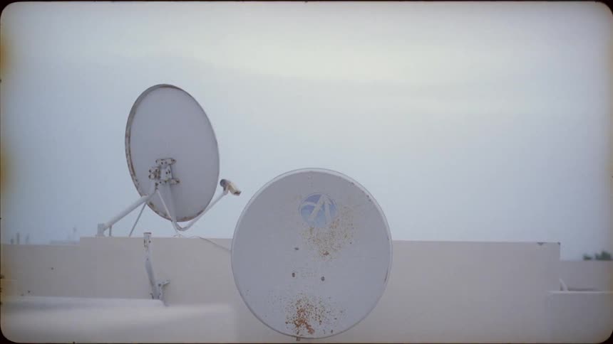 Satellite dishes are mounted to the rooftop