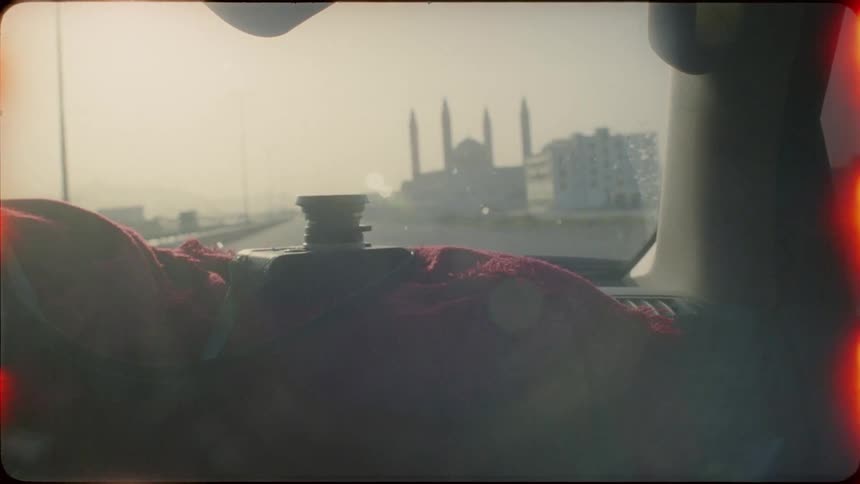 A camera on a blanket in a traveling car