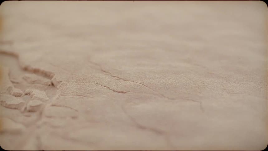 Sand crumbles and begins to fall