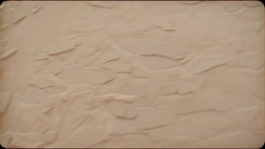 Sand on a dune slope shifts and slides down