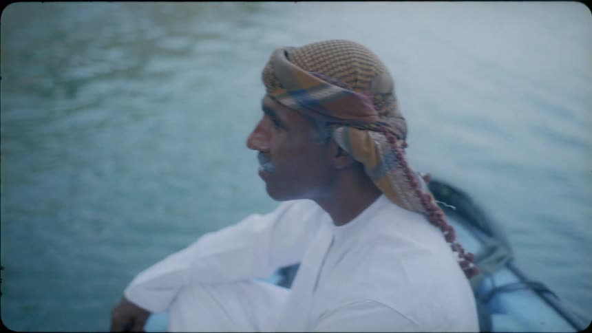 Man rides in the front of a boat