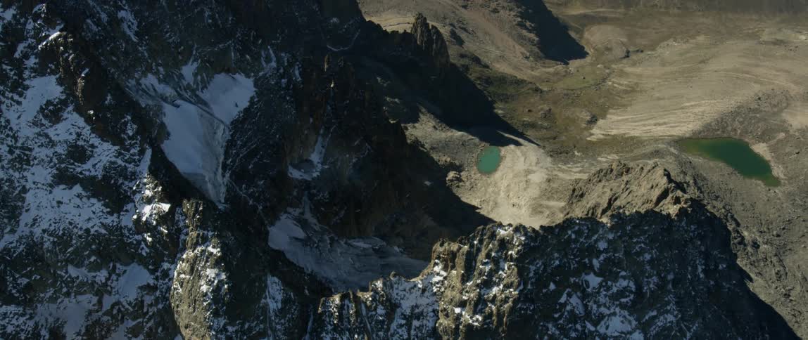 The mountain is covered with light snow