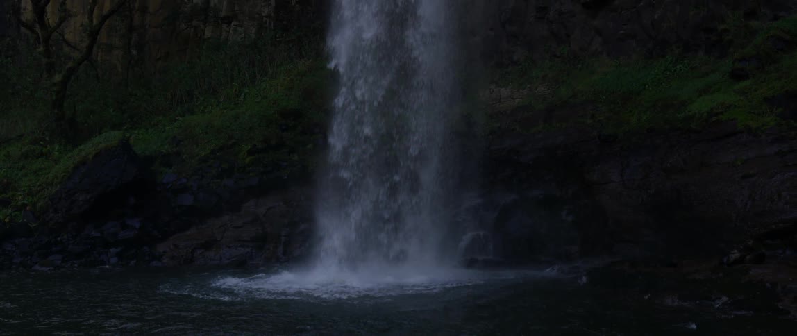 Water flows down the rocks and splashes into the stream below