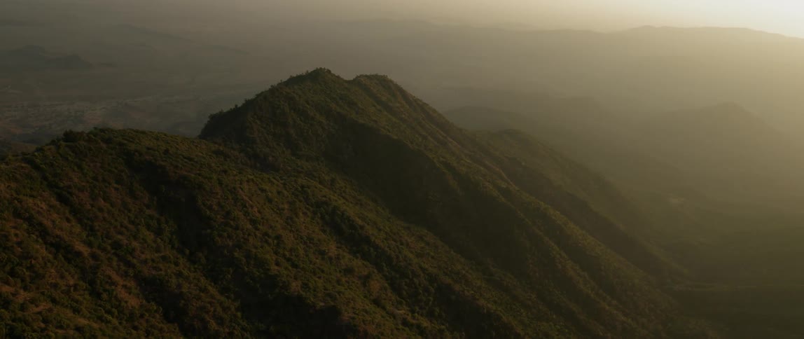 The mountain range is covered with fog