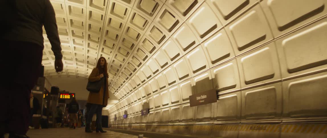 People wait in a subway station for the subway train