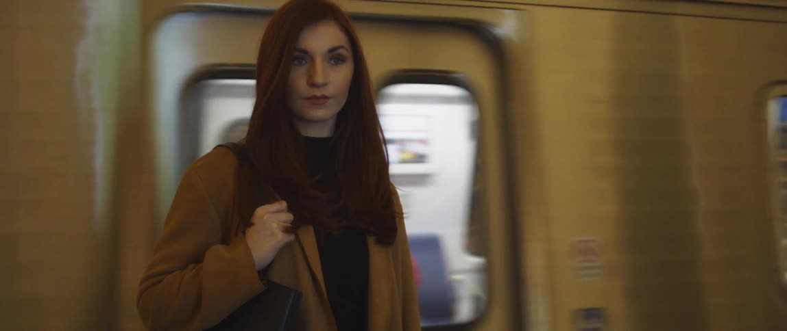 A woman waits at a subway station