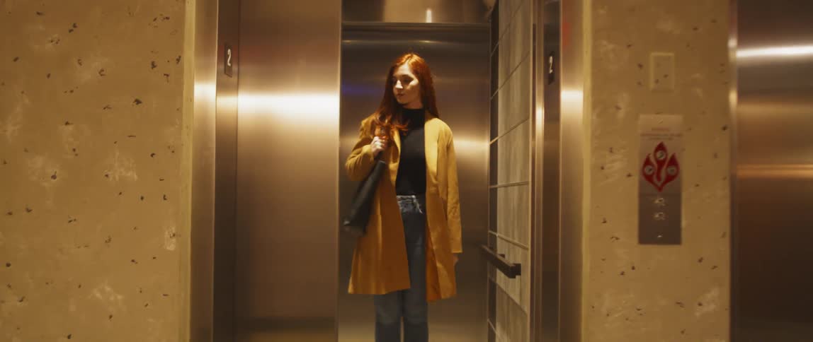 A woman enters an elevator