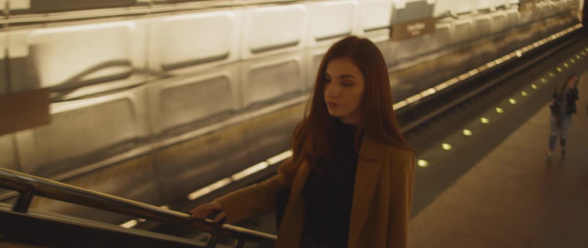 A woman walks up the subway stairs