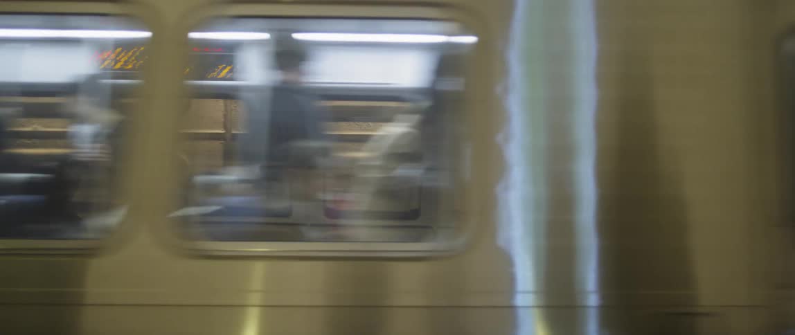 Train travels past a wall