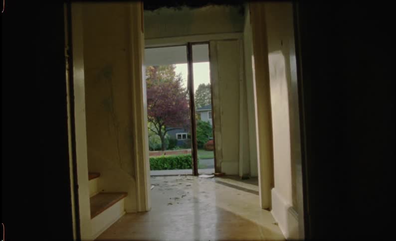 Empty hallway of a house with sun streaming in
